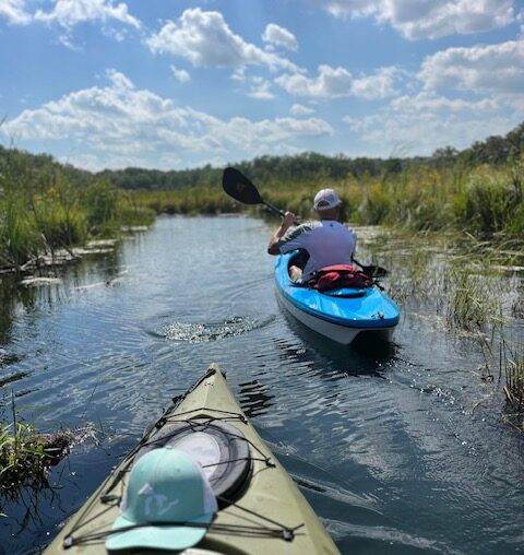 Two kayaks gliding through Lulu Lake, Wisconsin